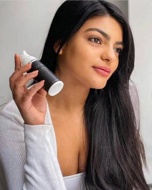 Woman with glowing skin using Calithea Olive Oil Night Cream with shea butter and berries